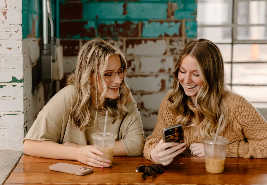 two women looking at a phone